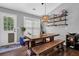 Bright dining area with an outside view through a glass door, wooden benches and table at 2582 Oak Bluff Dr, Dacula, GA 30019