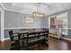 Stylish dining area features a modern light fixture and large window offering ample natural light at 2582 Oak Bluff Dr, Dacula, GA 30019