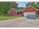Beautiful red brick home with a well-maintained lawn, landscaping, and long concrete driveway at 2582 Oak Bluff Dr, Dacula, GA 30019