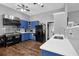 Modern kitchen with stainless steel appliances, blue cabinets, and a spacious countertop at 2582 Oak Bluff Dr, Dacula, GA 30019