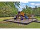 Community playground featuring colorful play structures on a safety surface at 2582 Oak Bluff Dr, Dacula, GA 30019