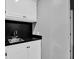 White vanity with a stainless steel sink and black countertop at 2582 Oak Bluff Dr, Dacula, GA 30019