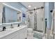 Modern bathroom with double sinks, a sleek shower with decorative tile, and contemporary lighting at 5008 Bethpage Dr, Suwanee, GA 30024