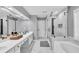Bright bathroom with dual sinks, a soaking tub, and a separate glass-enclosed shower at 5008 Bethpage Dr, Suwanee, GA 30024