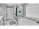Bathroom featuring a soaking tub and a glass-enclosed shower with modern fixtures at 5008 Bethpage Dr, Suwanee, GA 30024