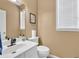 Bright bathroom featuring a sink, toilet, and framed mirror providing a refreshed, clean aesthetic at 5008 Bethpage Dr, Suwanee, GA 30024