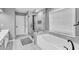 Bathroom featuring a soaking tub and a glass-enclosed shower with modern fixtures at 5008 Bethpage Dr, Suwanee, GA 30024