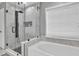 Bathroom featuring a soaking tub and a glass-enclosed shower with modern fixtures at 5008 Bethpage Dr, Suwanee, GA 30024