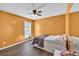 Bright bedroom with hardwood floors, ceiling fan, and a bed, creates a peaceful and welcoming ambiance at 5008 Bethpage Dr, Suwanee, GA 30024