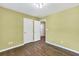 Neutral bedroom showcasing hardwood floors, light fixture, and closet at 5008 Bethpage Dr, Suwanee, GA 30024