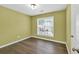 Cozy bedroom with hardwood floors and a large window, offering a serene and inviting atmosphere at 5008 Bethpage Dr, Suwanee, GA 30024