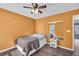 Inviting bedroom features hardwood floors, ceiling fan, queen-sized bed, and cozy lighting at 5008 Bethpage Dr, Suwanee, GA 30024