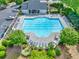 Aerial shot of the community pool with ample seating, landscaping, and a well-maintained pool house at 5008 Bethpage Dr, Suwanee, GA 30024