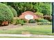 Townsend Creek entrance sign with manicured landscaping featuring colorful flowers and lush greenery at 5008 Bethpage Dr, Suwanee, GA 30024