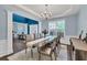 Dining room showcases an elegant chandelier, large dining table, and seamless connection to the open-concept layout at 5008 Bethpage Dr, Suwanee, GA 30024