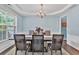 Charming dining room featuring a modern chandelier, a large window, and ample space for entertaining guests at 5008 Bethpage Dr, Suwanee, GA 30024