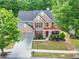 Well-maintained two-story home featuring brick facade and mature landscaping at 5008 Bethpage Dr, Suwanee, GA 30024