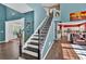Bright foyer with staircase leading to the second floor and views into the living spaces at 5008 Bethpage Dr, Suwanee, GA 30024