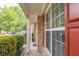 Charming brick front porch features elegant columns and a view of the lush, landscaped yard at 5008 Bethpage Dr, Suwanee, GA 30024