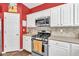 Charming kitchen features stainless steel appliances and white cabinets, providing a modern and inviting space at 5008 Bethpage Dr, Suwanee, GA 30024