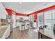 Bright kitchen with white cabinets, an island with bar seating, stainless steel appliances, and hardwood floors at 5008 Bethpage Dr, Suwanee, GA 30024