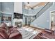 Inviting living room with a cozy fireplace, hardwood floors, and staircase at 5008 Bethpage Dr, Suwanee, GA 30024