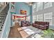 Open-concept living room with bright kitchen, staircase, and large windows at 5008 Bethpage Dr, Suwanee, GA 30024