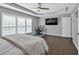 Spacious main bedroom with hardwood floors, tray ceiling, and a desk set up for work at 5008 Bethpage Dr, Suwanee, GA 30024