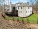 The rear exterior showcasing a spacious elevated deck and landscaped yard, perfect for outdoor enjoyment at 120 Nezhat Pl, Atlanta, GA 30350