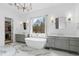 Luxurious primary bathroom with marble floors, double vanities, freestanding tub, and large window views at 120 Nezhat Pl, Atlanta, GA 30350