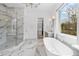 Elegant primary bathroom featuring a glass shower, tub, double vanity, and marble flooring at 120 Nezhat Pl, Atlanta, GA 30350