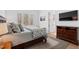 Comfortable bedroom with large windows, wooden dresser, a bed with plush pillows, and a calming ambiance at 120 Nezhat Pl, Atlanta, GA 30350