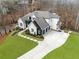 An aerial view showcasing a large yard and driveway, complemented by a modern black and white exterior at 120 Nezhat Pl, Atlanta, GA 30350