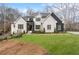 Beautiful two-story home featuring fresh green lawn, landscaping, and a striking black and white exterior at 120 Nezhat Pl, Atlanta, GA 30350