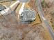 Bird's eye view of a stately home with a deck area, situated amongst a sparse winter forest at 120 Nezhat Pl, Sandy Springs, GA 30350