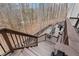 Expansive back deck featuring outdoor seating and stairs to a wooded lot at 120 Nezhat Pl, Sandy Springs, GA 30350