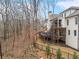 Expansive backyard featuring a spacious deck and manicured landscaping, surrounded by bare trees at 120 Nezhat Pl, Sandy Springs, GA 30350