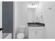 Modern bathroom with sleek vanity, dark countertop, and gray tiled accent wall at 120 Nezhat Pl, Sandy Springs, GA 30350