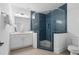 Modern bathroom featuring a frameless glass shower with blue tile and white cabinetry at 120 Nezhat Pl, Sandy Springs, GA 30350