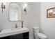 Elegant powder room with marble countertop, black cabinets, modern fixtures, and decorative wall tiling at 120 Nezhat Pl, Sandy Springs, GA 30350