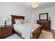 A spacious bedroom with dark wood furnishings and a plush bed at 120 Nezhat Pl, Sandy Springs, GA 30350