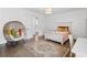 A well-lit bedroom featuring a unique hanging chair and hardwood flooring at 120 Nezhat Pl, Sandy Springs, GA 30350