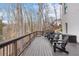 Spacious wooden deck with black chairs offering serene views of the surrounding trees and water at 120 Nezhat Pl, Sandy Springs, GA 30350