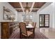 Formal dining room features wood-coffered ceilings, large window, and sideboard with decor at 120 Nezhat Pl, Sandy Springs, GA 30350