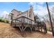 Beautiful house exterior showing deck with railings, situated on a landscaped hillside at 120 Nezhat Pl, Sandy Springs, GA 30350