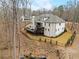An expansive home is nicely landscaped with a large rear deck and black aluminum fencing at 120 Nezhat Pl, Sandy Springs, GA 30350