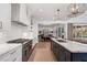 Open kitchen view showcasing the island, range, and connection to the adjacent living spaces at 120 Nezhat Pl, Sandy Springs, GA 30350