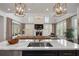 Close-up of the kitchen island with a marble countertop and stainless steel sink at 120 Nezhat Pl, Sandy Springs, GA 30350
