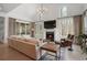 Bright living room with a fireplace, large windows, and comfortable seating at 120 Nezhat Pl, Sandy Springs, GA 30350