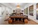 Open concept living room features a wooden table, leather ottomans, and gallery shelves at 120 Nezhat Pl, Sandy Springs, GA 30350